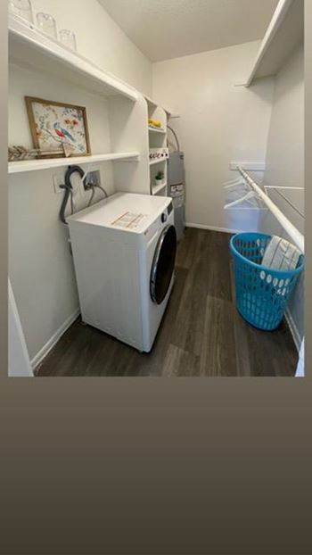 A small laundry room with a washer and dryer.